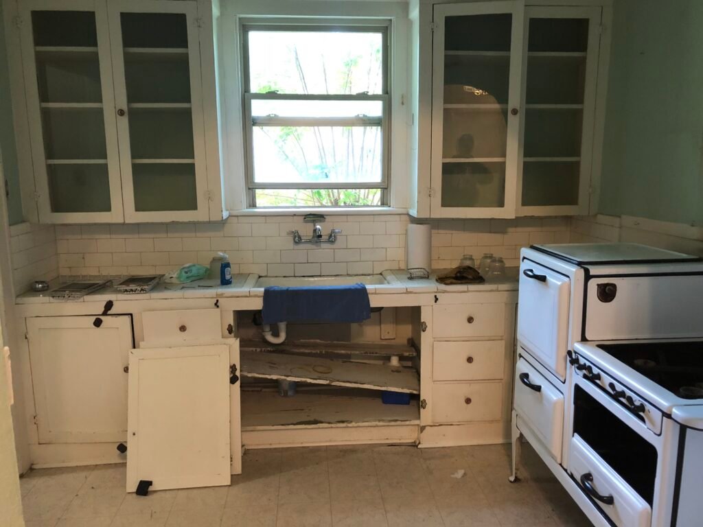 Cluttered, lived-in kitchen bought as-is, no cleanout required